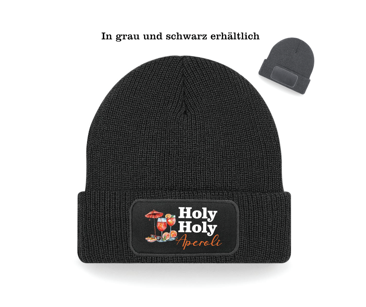 Schwarze Beanie mit Text Holy Holy Aperoli und einem Cocktail Aperol daneben