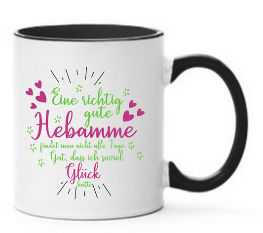 Schwarze Tasse mit Aufdruck Eine richtig gute Hebamme findet man nicht alle Tage Gut, dass ich soviel Glück hatte mit Herzen. Aufdruck in grün und Pink