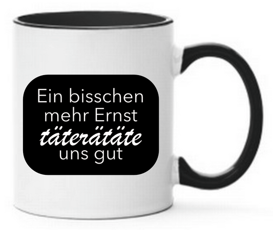 Schwarze Tasse mit Spruch Ein bisschen mehr Ernst täterätete uns gut